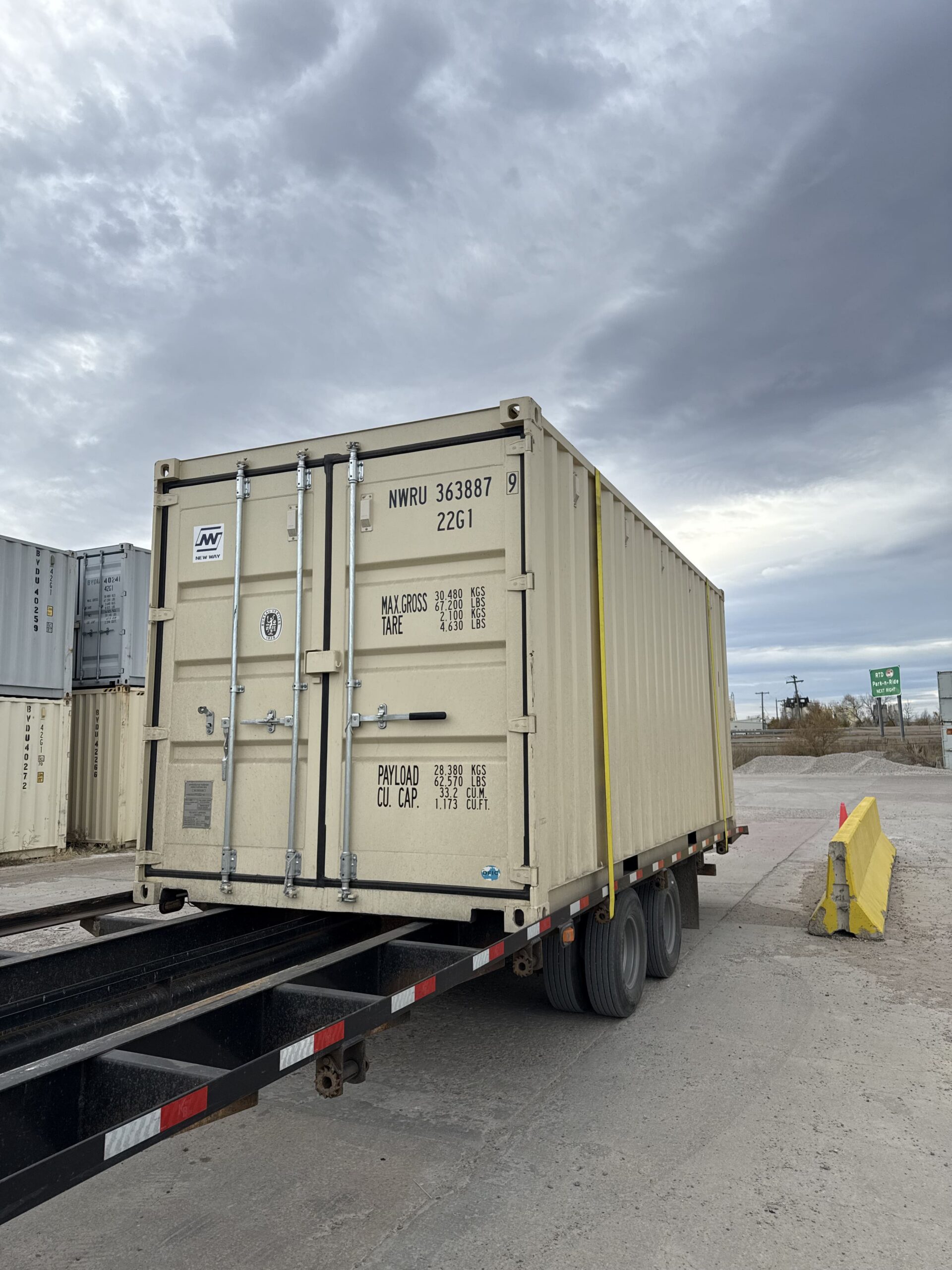 20 foot shipping container delivered on a tilt-bed truck in Denver, CO
